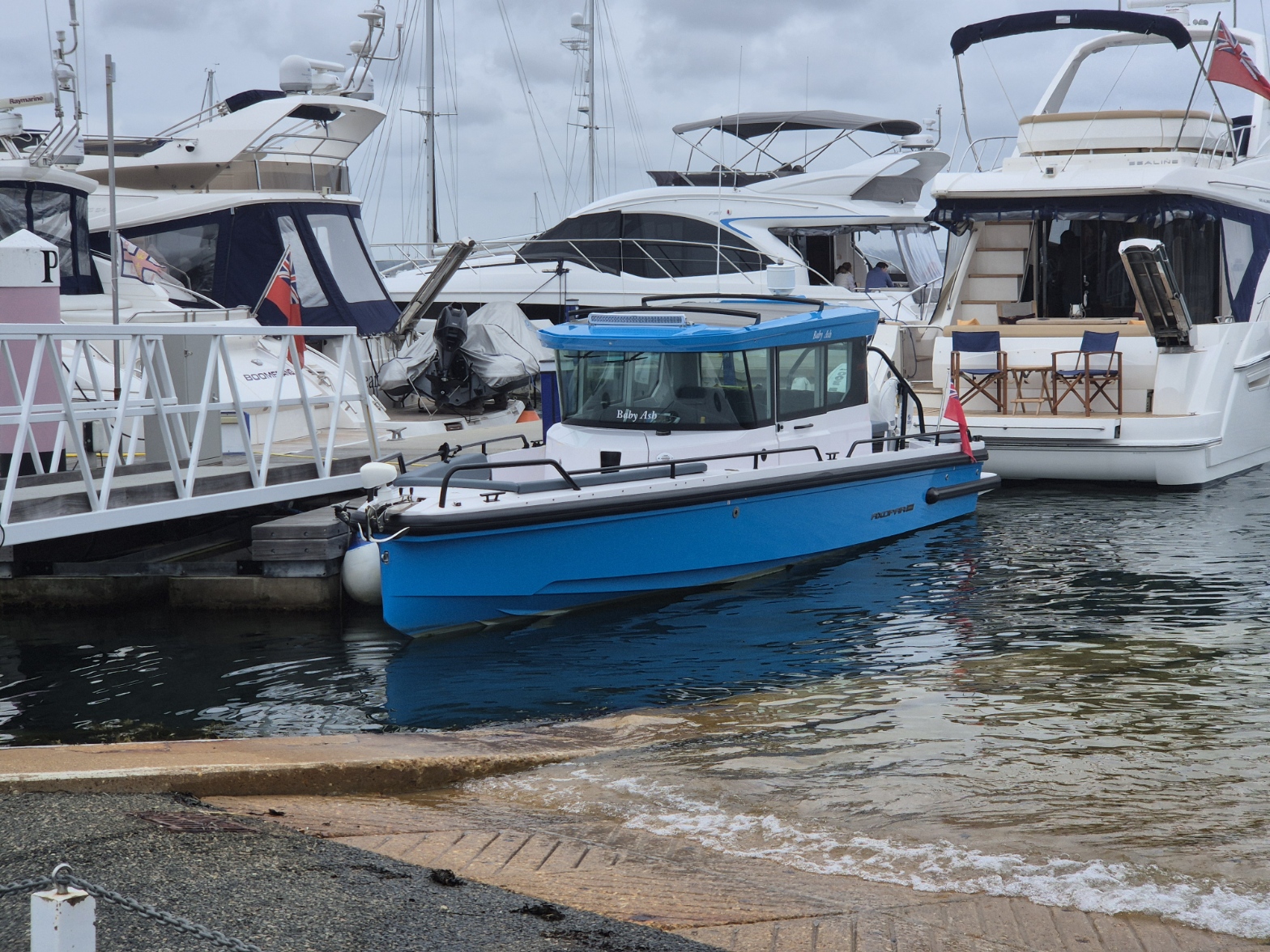 Blue Axopar boat moored in a marina