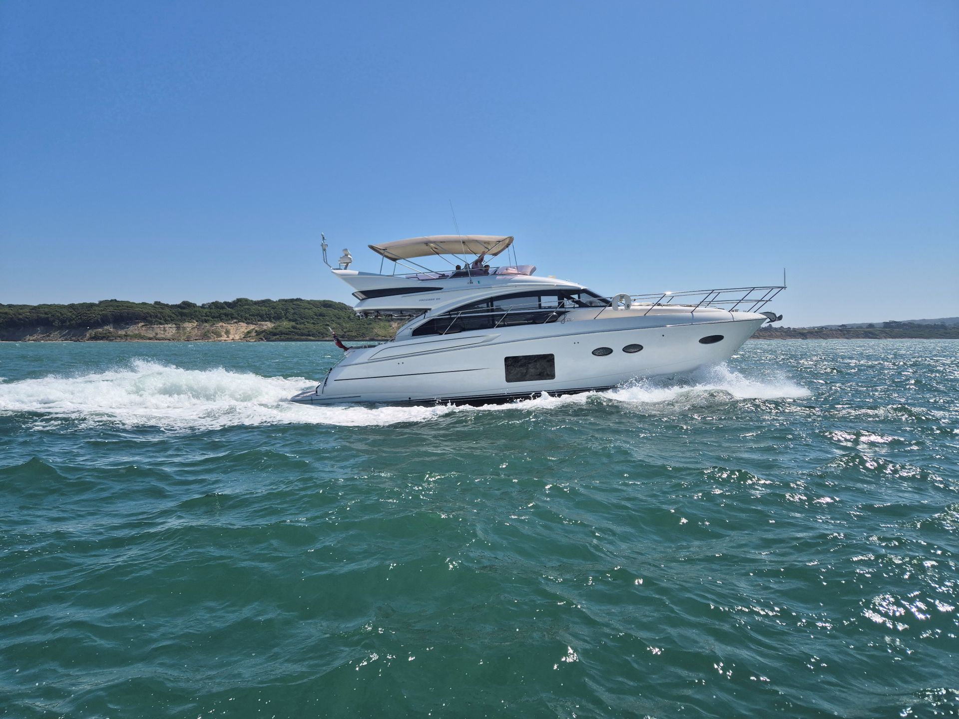 Princess motor cruiser on the Solent with coastline in the background